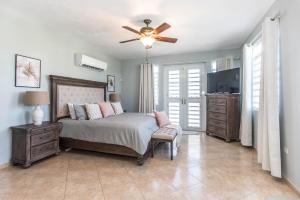 a bedroom with a bed and a ceiling fan at Casa Cielo in Rincon