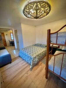 1 dormitorio con cama y lámpara de araña en Cabañas San Pedro de Atacama., en San Pedro de Atacama