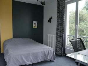 a bedroom with a bed and a large window at Villa piscine city center / 15 min Chps Elysées in Nanterre