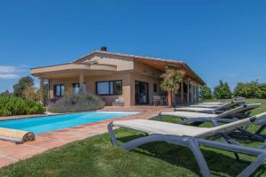 een rij ligstoelen voor een huis bij Villa de vacaciones con encanto El Serrat in Vilafreser