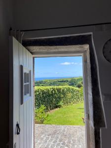 an open door with a view of a field at Home Near the Clouds - Refúgio in Nordeste