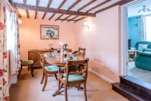 a dining room with a table and chairs at The Old Shop, No 12 in Framlingham