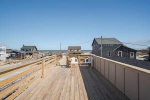 a large deck with a table and chairs on it at 5453 - Sand Fiddler in Nags Head