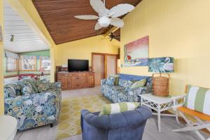 a living room with blue couches and a tv at 5453 - Sand Fiddler in Nags Head