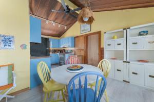 a kitchen with a table and chairs in a room at 5453 - Sand Fiddler in Nags Head