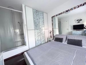 a bedroom with a bed and a glass shower at Apartment Sweet Dreams-Maksimir Ravnice-ZOO-free parking in Zagreb