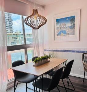 a dining room with a table and chairs at KASA Galicia by the Sea - Cabana Studio Apt for 2 BEACHFRONT CONDO POOL in San Juan