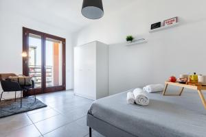 a bedroom with a bed and a table and a chair at Sarca 11th Floor in Milan