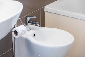a bathroom with a white toilet and a sink at Sarca 11th Floor in Milan +15 photos
