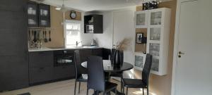 a kitchen with a table and chairs in a kitchen at Country Dream - Langholt 2 in Selfoss
