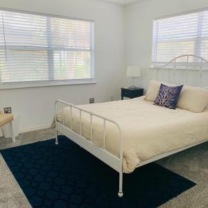a bedroom with a bed with a white bed frame at Beachfront House Pine Island, Tampa, Orlando in Weeki Wachee