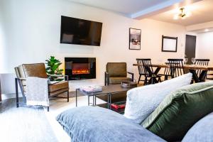 a living room with a couch and a table and a fireplace at The Revy Dream in Revelstoke