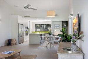 阳光海岸Noosa gem! Walking distance to cafes - shops - Sunshine Beach and dog Beach的配有桌椅的厨房和客厅