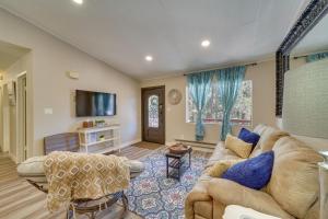 a living room with a couch and a tv at Wraparound Deck Breezy Pinez Cabin in Pine! in Pine