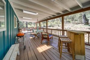 a screened porch with a table and chairs on it at Wraparound Deck Breezy Pinez Cabin in Pine! in Pine