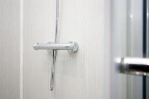 a shower head on a door with a chain at Skyline Remarkable 2-Bed Apartment in Swansea in Swansea