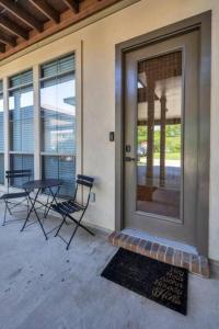 a front door of a house with a table and chairs at Stylish & Romantic Home, Long-term friendly, King in Baton Rouge