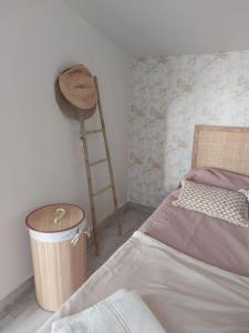 a bedroom with a bed and a ladder and a trash can at Casa Tropicana in Paul do Mar