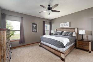 a bedroom with a bed and a ceiling fan at RECONNECT the LINE with Friends & Family - 7 King Bed in Hollister +60 photos