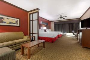 a hotel room with a bed and a couch at Best Western Plus Classic Inn and Suites in Center