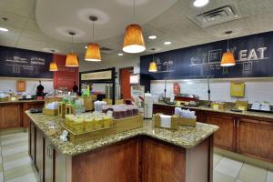 a fast food restaurant with a counter with food at Hampton Inn Raleigh/Town of Wake Forest in Wake Forest