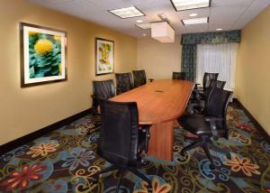 a conference room with a wooden table and chairs at Hampton Inn Raleigh/Town of Wake Forest in Wake Forest