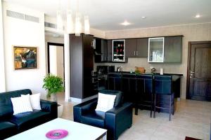 A kitchen or kitchenette at Sleek & Cozy Apartment with Pool & Patio In Abdoun