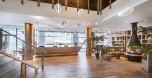 a lobby with a wooden boat in a building at Hilton Auckland in Auckland