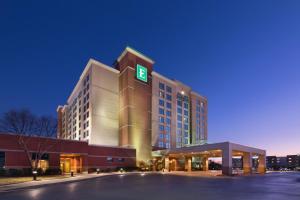 a hotel with a green sign on top of it at Embassy Suites Murfreesboro - Hotel & Conference Center in Murfreesboro