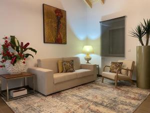 a living room with a couch and a chair at THE ORANGE TREE HOUSES - Terraço by Live and Stay in Abrantes +4 photos