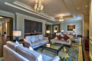 a living room with couches and a chandelier at Hilton Nay Pyi Taw in Nay Pyi Taw