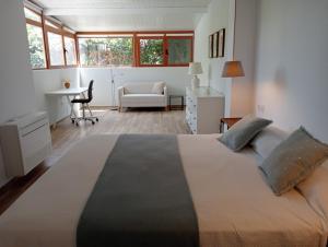 una camera con un grande letto e una scrivania di Mayarí a Moraira