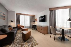 a living room with a couch and a table at Hilton Garden Inn Toronto Airport in Mississauga