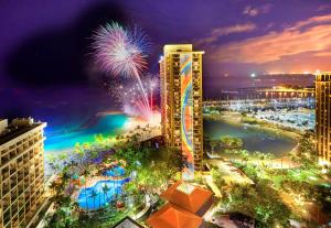 a view of a city with fireworks in the background at Hilton Hawaiian Village Waikiki Beach Resort in Honolulu