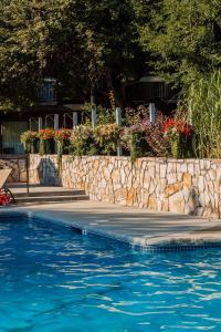 a swimming pool with blue water and a stone wall at Best Western Sunridge Inn & Conference Center in Baker City