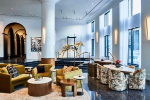 a lobby with couches and tables in a building at Daxton Hotel in Birmingham