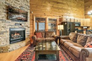 a living room with couches and a fireplace at Cabin-n-Smokys! Indoor Resort Pool Views Hot Tub Game Room in Sevierville