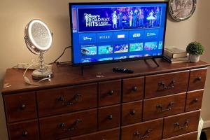 a television on top of a dresser with a mirror at Entire house 3 bedroom Twin Cities, Specious, Entire House, AC in Saint Paul