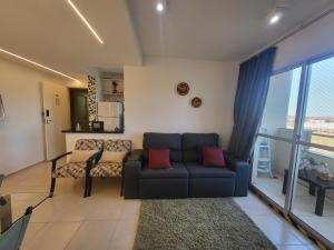 a living room with a couch and a table at APTO ENCANTADOR, PISCINA, ACADEMIA E MUITO MAIS. in Campo Grande