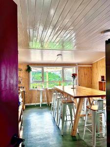 a kitchen with a large wooden table and chairs at Refugio Ballena Hostel in Castro