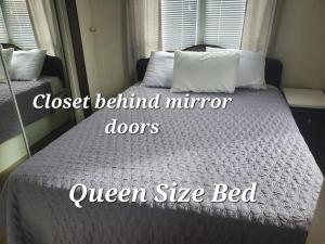 a bed in a bedroom with the words queen size bed at Boardwalk RV Rental (Site #14) in Cavendish