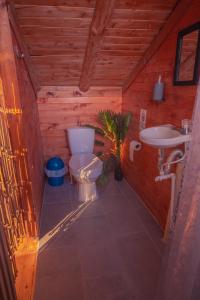 a small bathroom with a toilet and a sink at EVA Glamping in Santa Elena