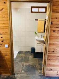 a small bathroom with a sink and a toilet at Bungalow KURA in Moorea