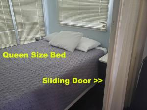 a bedroom with a bed with two pillows and a window at Boardwalk RV Rental Site #19 in Cavendish