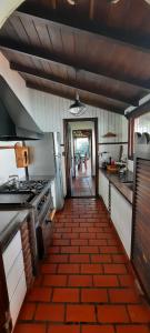 a kitchen with a tile floor and a hallway at Chalet Playa Grande in Mar del Plata