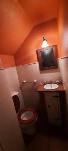 a small bathroom with a toilet and a sink at Chalet Playa Grande in Mar del Plata