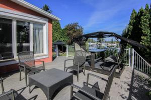 a patio with chairs and a table and a gazebo at La Perle Rose du Lac-St-Jean in Roberval