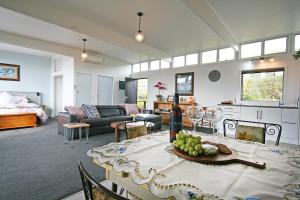 a living room with a dining table and a living room at Bella Park - New Plymouth Holiday Studio in New Plymouth
