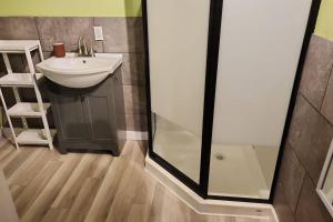 a bathroom with a sink and a shower at cozy apartment near the ocean in Guysborough