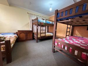 a bedroom with two bunk beds and a bed with a bed sqor at Greenhouse Bolivia in La Paz